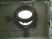 A brass two flap porthole